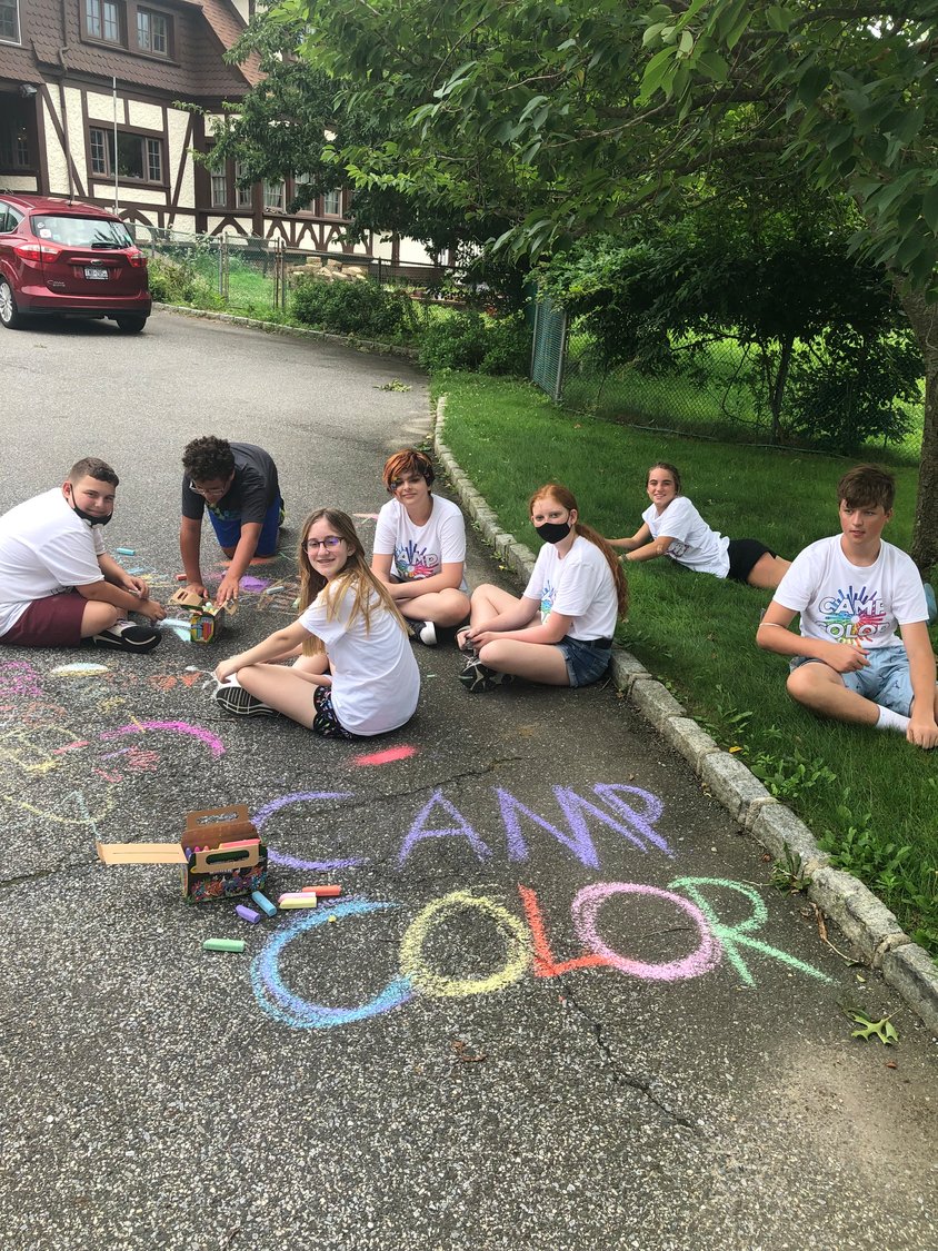 Students from Camp Color decorate with sidewalk chalk.
